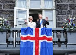 Helga Tómasdóttir, the new President of Iceland, and her husband Björn Skúlason, greet the crowd that were celebrating on Austurvöllur in front of Althingi Parliament.