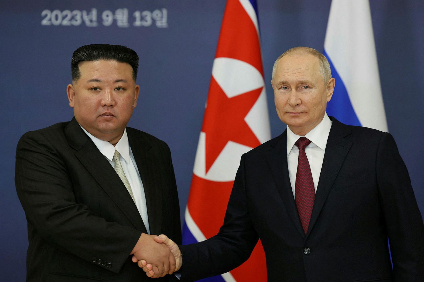 Kim Jong-un og Pútín takast í hendur.